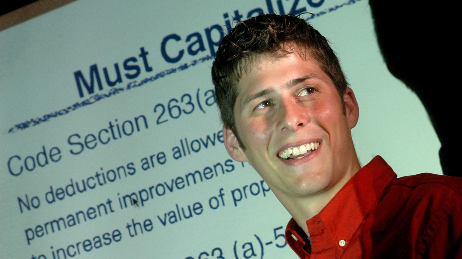 photo of man in front of PowerPoint slide