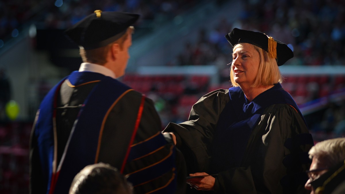 Dean Grasso shakes graduate's hand