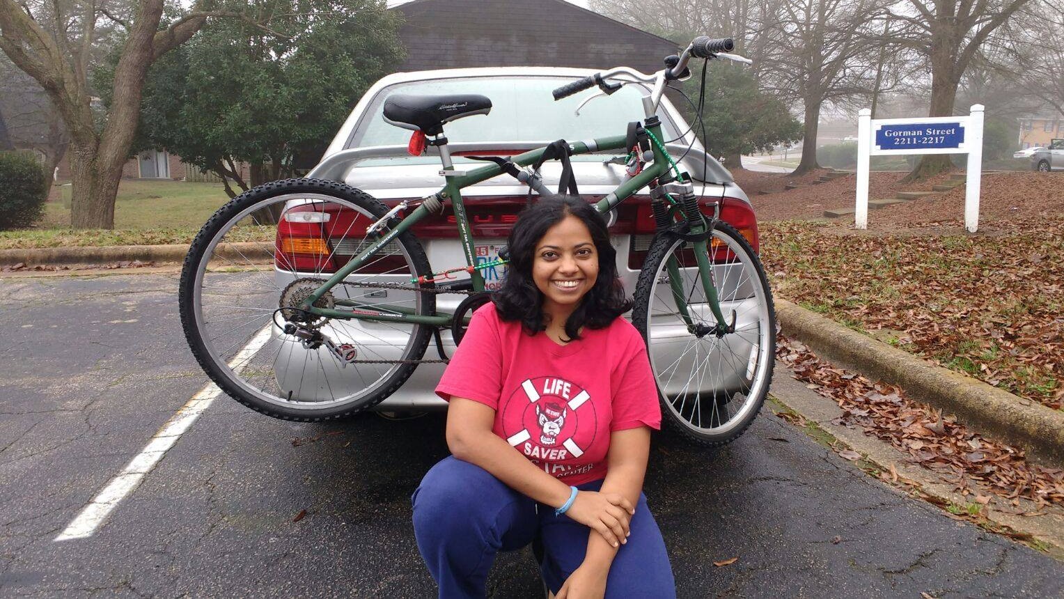 Haritha besid her car and bike