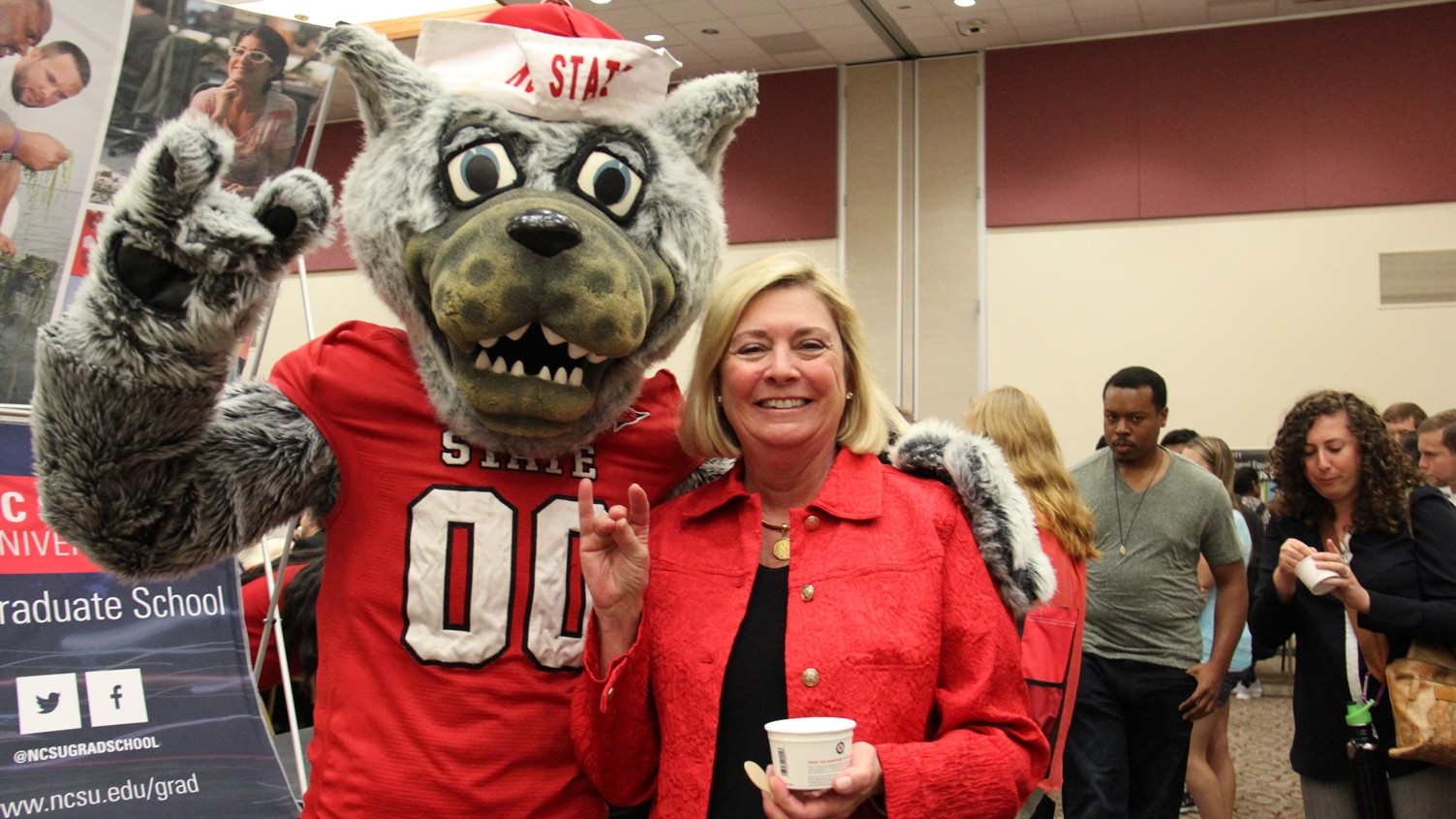 Mr. Wuf and Dean Grasso give "go Pack" sign