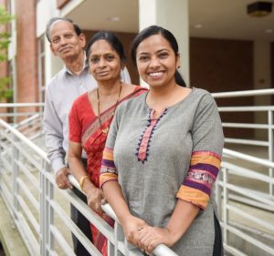 Haritha Malladi stands with her parents