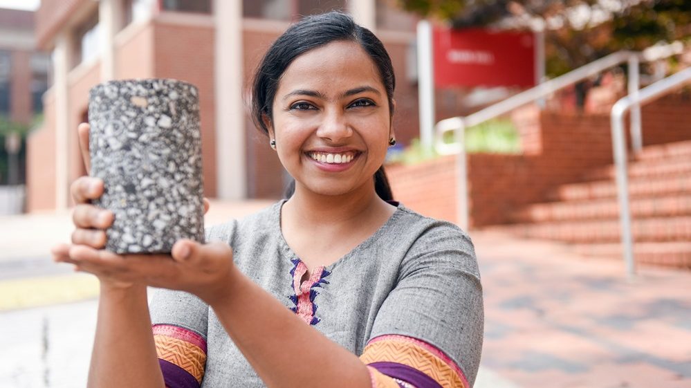 Haritha holds a block of asphalt