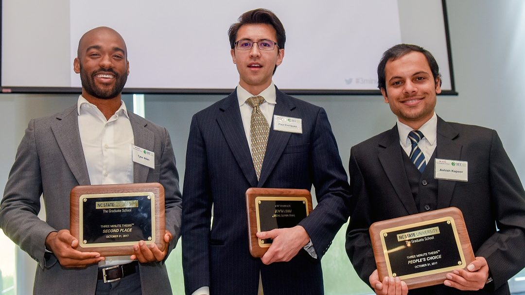 three winners with their plaques