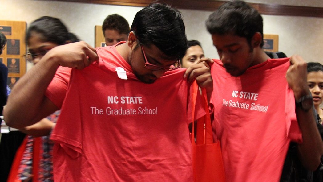 two students hold t-shirt