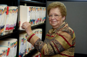 Peggy stands in the records room