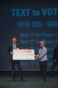 Majeski holds large check