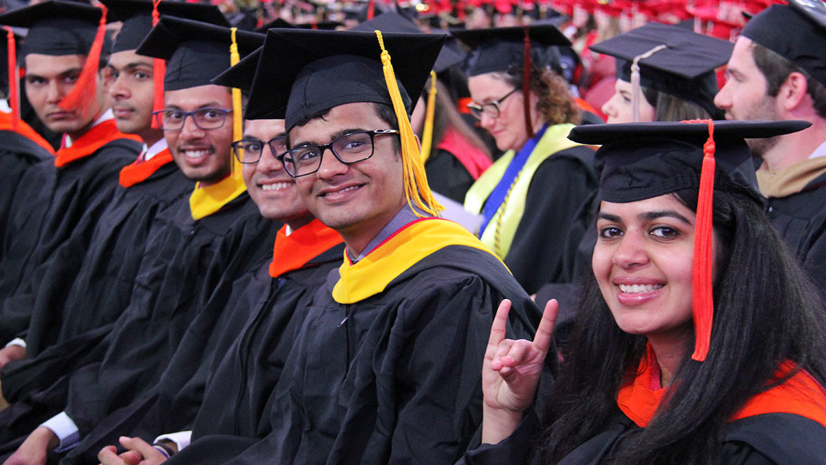 master's students give go pack sign