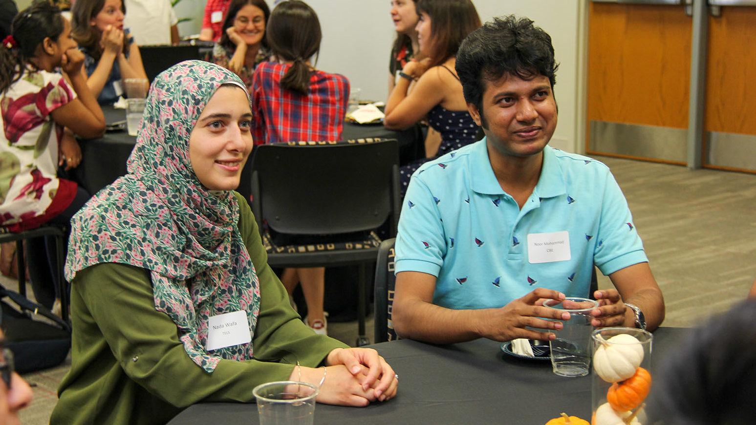 two scholars sitting at a table