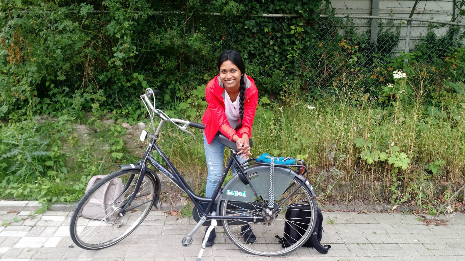 Sanjana Curtis leaning against a bicycle