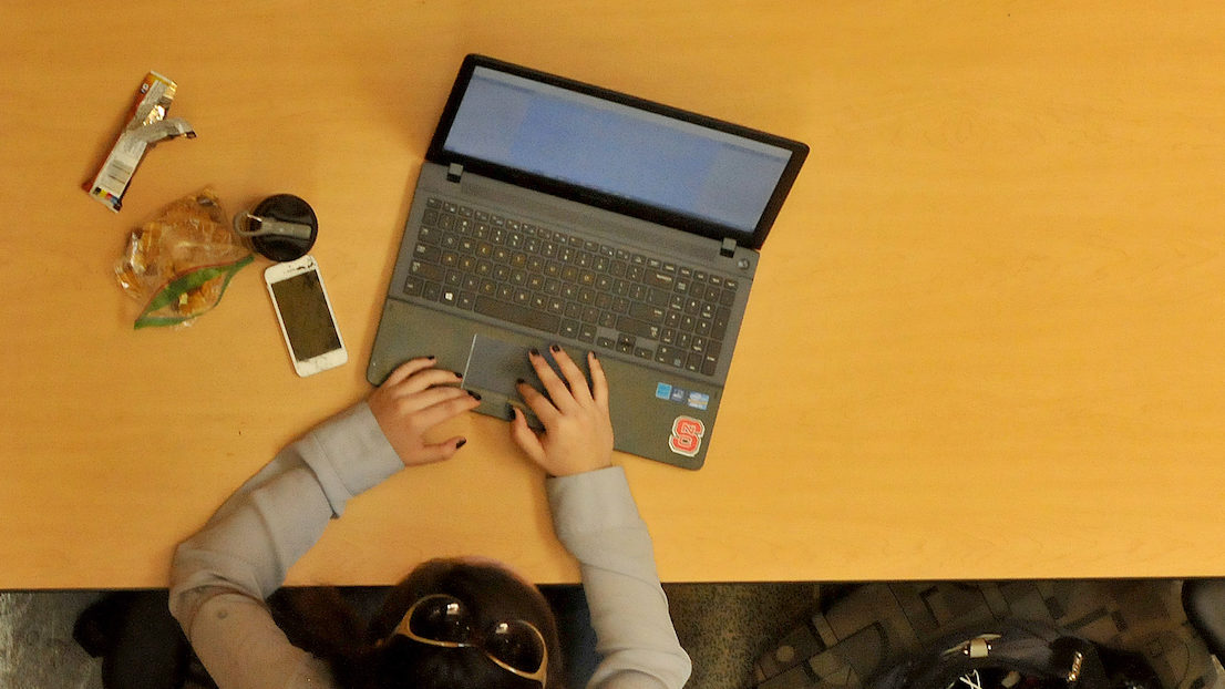 Student works on her laptop in EB1 on Centennial Campus.