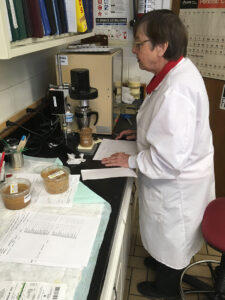 Jessie Rivers in the laboratory, working on a piece of equipment