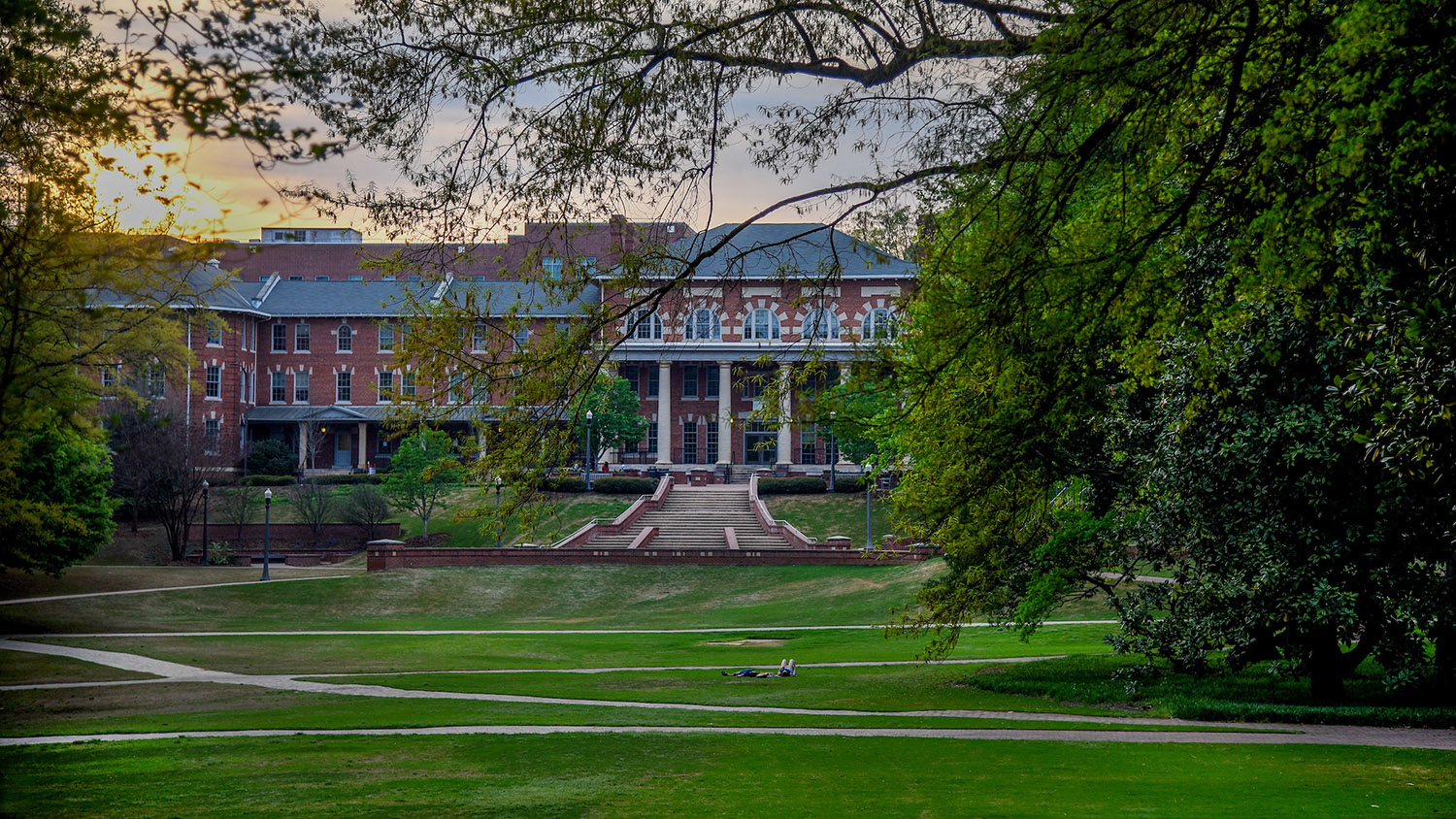 sun sets over brick building