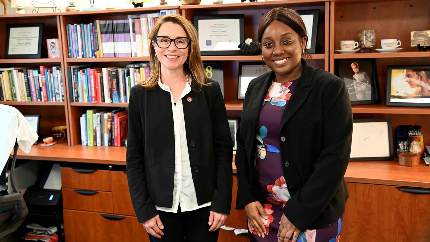 Ayele Kuevidjen (right) and College of Humanities and Social Sciences Dean Deanna Dannels.