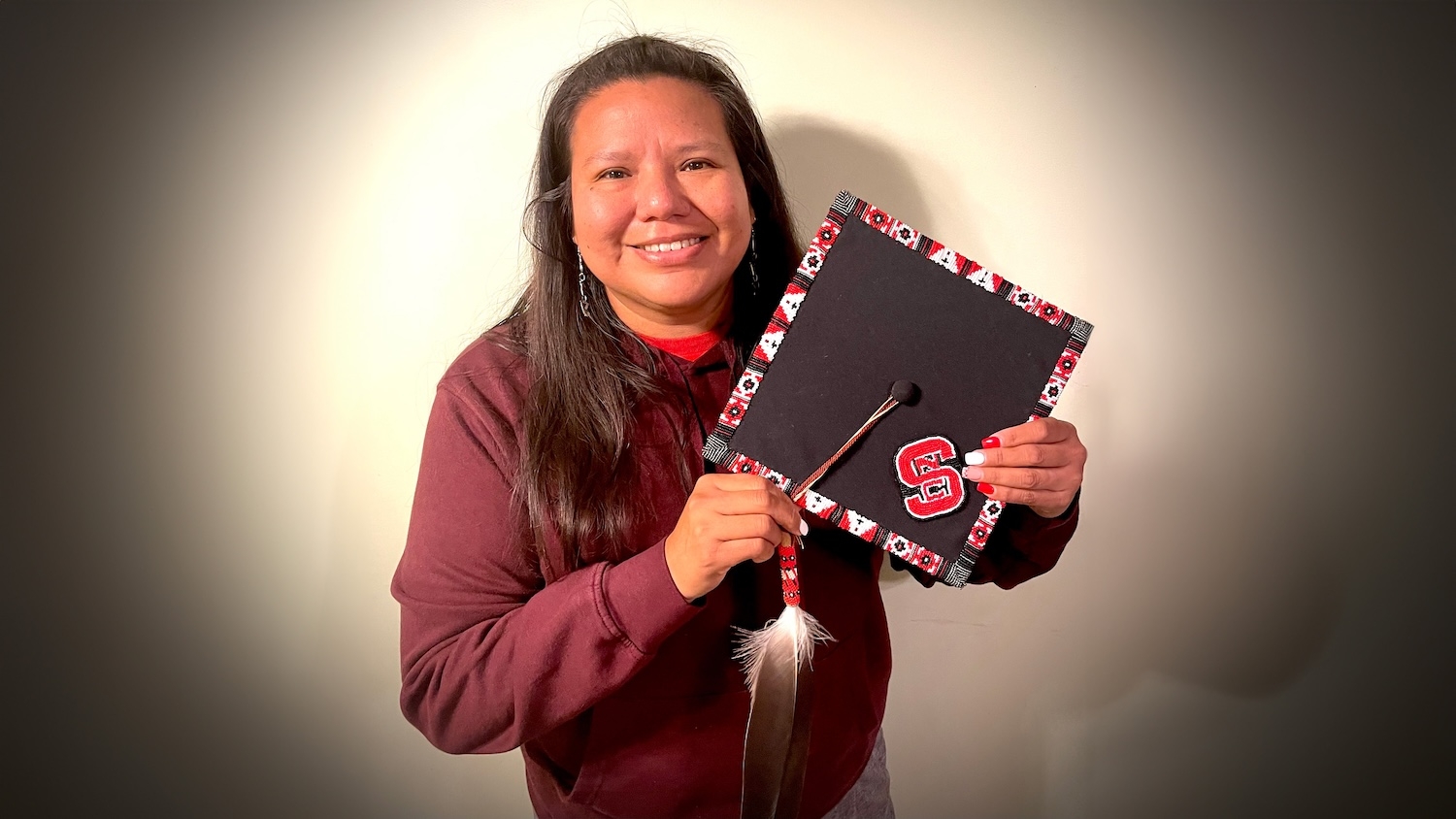 Kami Lanning poses with her beaded graduation cap.