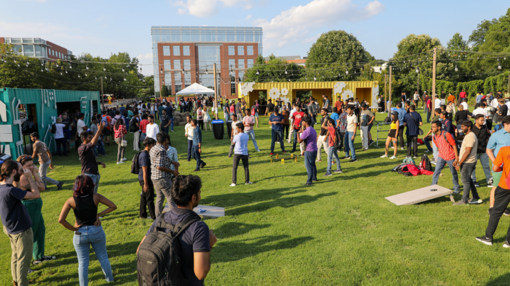 Graduate students enjoying large social event at the Corner on Centennial Campus