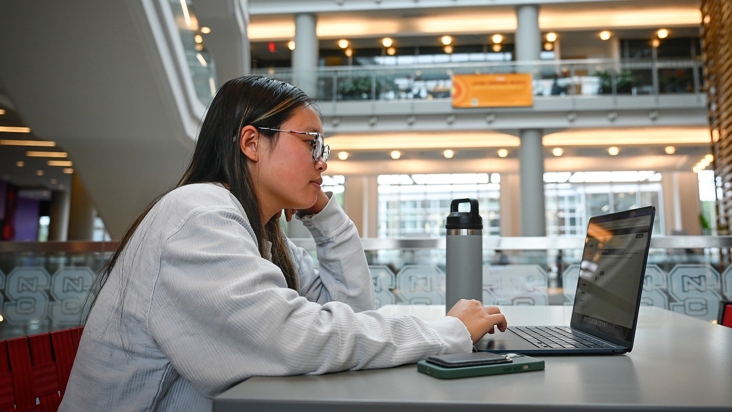 student sitting in front of laptop in Talley Student Center
