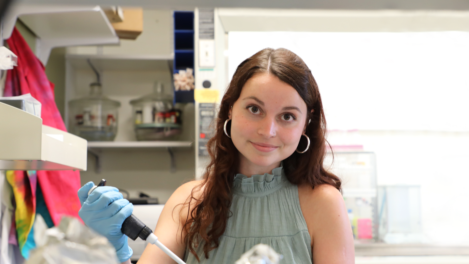 Postdoctoral Scholar Dr. Mallory Thomas working in lap. 